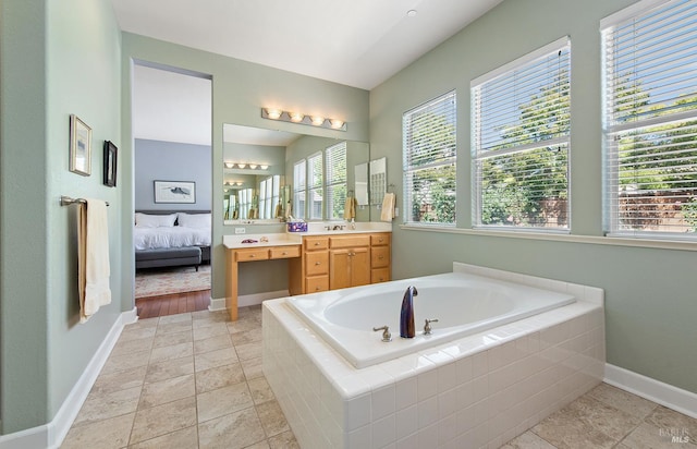 8596 Starr Rd, Windsor, CA 95492 - ensuite bathroom featuring a garden tub, vanity, and baseboards