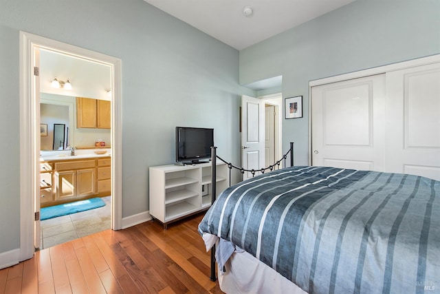 8596 Starr Rd, Windsor, CA 95492 - bedroom with wood finished floors, baseboards, a closet, a sink, and ensuite bath