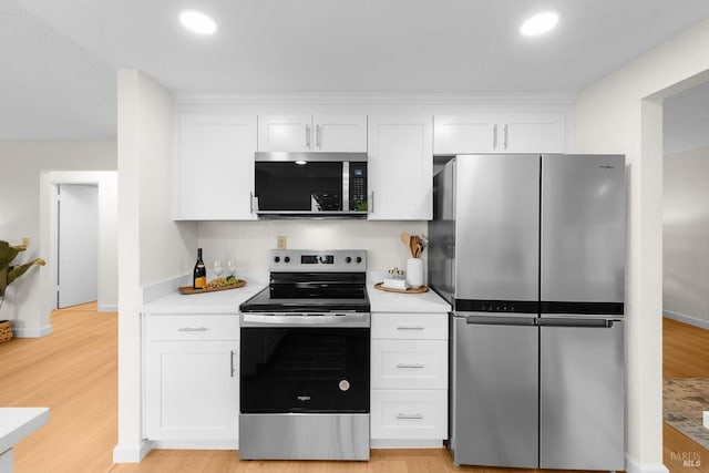 225 Riverview Dr, Vallejo, CA 94589 - kitchen featuring stainless steel appliances, white cabinets, light countertops, light wood-style floors, and recessed lighting