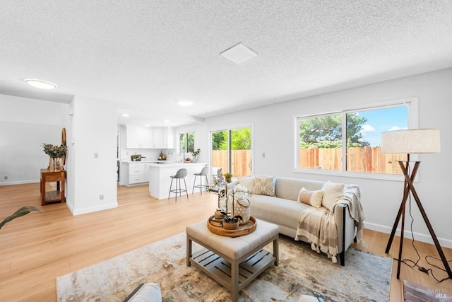 225 Riverview Dr, Vallejo, CA 94589 - living area with a textured ceiling, light wood-style floors, and baseboards