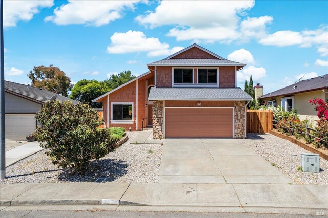 225 Riverview Dr, Vallejo, CA 94589 - view of front facade featuring driveway, stone siding, an attached garage, and a shingled roof