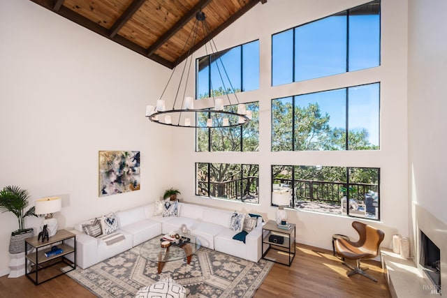 1043 La Quinta Ct, Napa, CA 94559 - living room featuring high vaulted ceiling, wood ceiling with exposed beams, wood finished floors, a chandelier, and baseboards