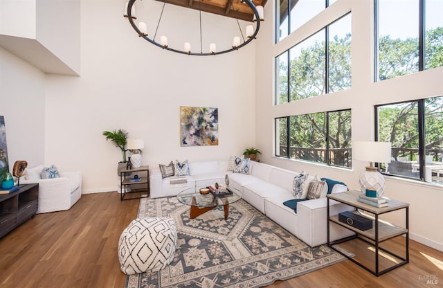1043 La Quinta Ct, Napa, CA 94559 - living room with a high ceiling, wood finished floors, baseboards, and a chandelier