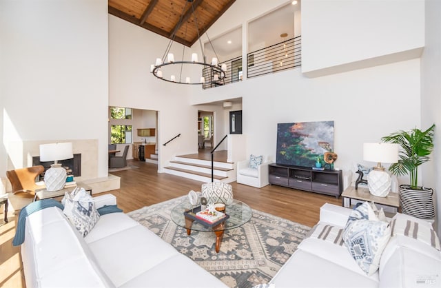 1043 La Quinta Ct, Napa, CA 94559 - living room with wood ceiling with exposed beams, wood finished floors, high vaulted ceiling, a chandelier, and stairs