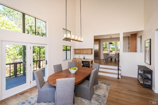 1043 La Quinta Ct, Napa, CA 94559 - dining room featuring a towering ceiling, beverage cooler, wood finished floors, and baseboards