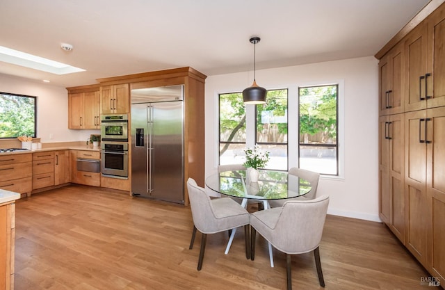 1043 La Quinta Ct, Napa, CA 94559 - dining area with a skylight, light wood-style floors, and baseboards