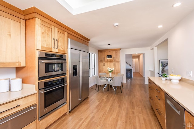 1043 La Quinta Ct, Napa, CA 94559 - kitchen featuring appliances with stainless steel finishes, light wood finished floors, light countertops, a warming drawer, and recessed lighting