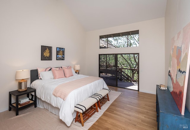 1043 La Quinta Ct, Napa, CA 94559 - bedroom with high vaulted ceiling, access to exterior, baseboards, and light wood-style floors