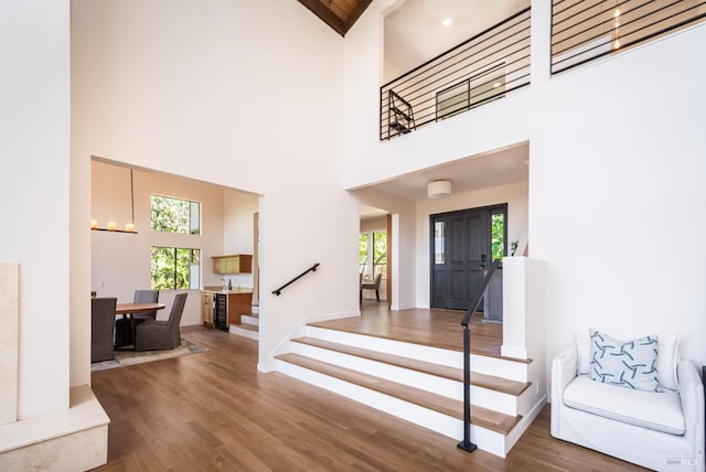 1043 La Quinta Ct, Napa, CA 94559 - entrance foyer featuring healthy amount of natural light, high vaulted ceiling, stairway, wood finished floors, and baseboards