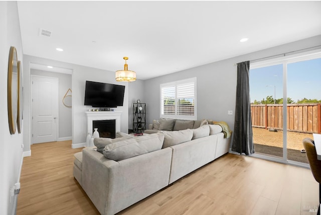 840 Allegro Ct, Fairfield, CA 94534 - living room featuring light wood-style floors, recessed lighting, a fireplace, baseboards, and arched walkways