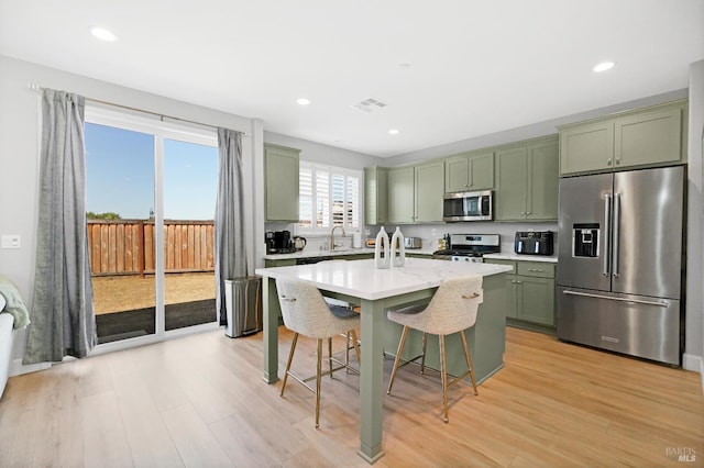 840 Allegro Ct, Fairfield, CA 94534 - kitchen featuring appliances with stainless steel finishes, green cabinets, a sink, light wood-style floors, and recessed lighting