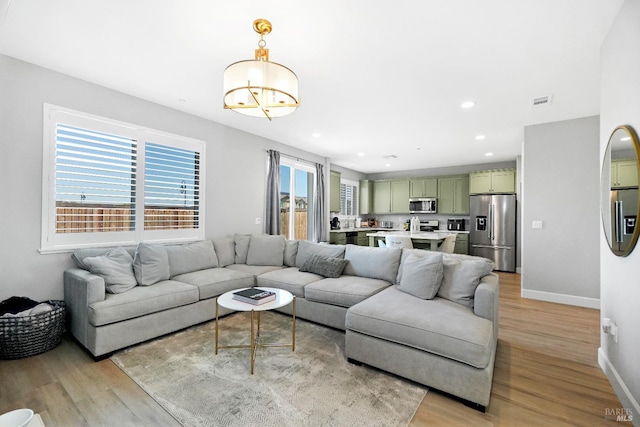 840 Allegro Ct, Fairfield, CA 94534 - living room featuring light wood-style flooring, baseboards, recessed lighting, and a chandelier