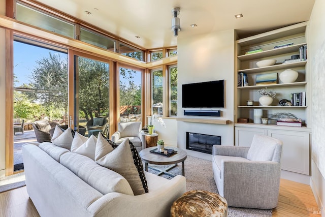 1067 Darms Ln, Napa, CA 94558 - living room featuring a glass covered fireplace and wood finished floors