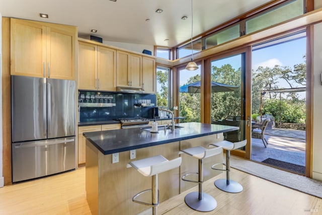 1067 Darms Ln, Napa, CA 94558 - kitchen featuring appliances with stainless steel finishes, a sink, dark countertops, light brown cabinets, and backsplash