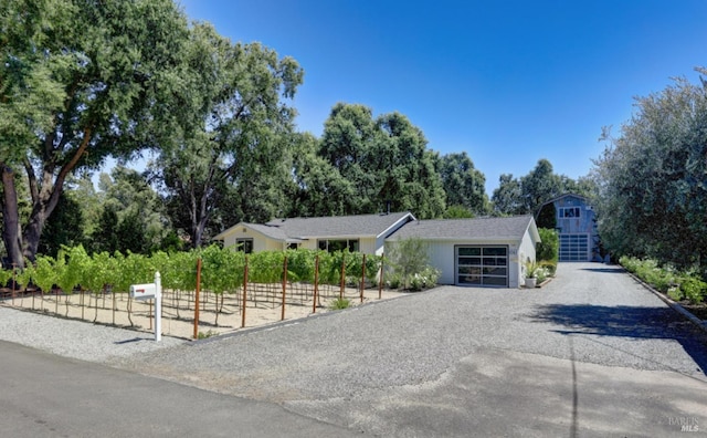 1067 Darms Ln, Napa, CA 94558 - view of front of home with driveway, a garage, and view of scattered trees