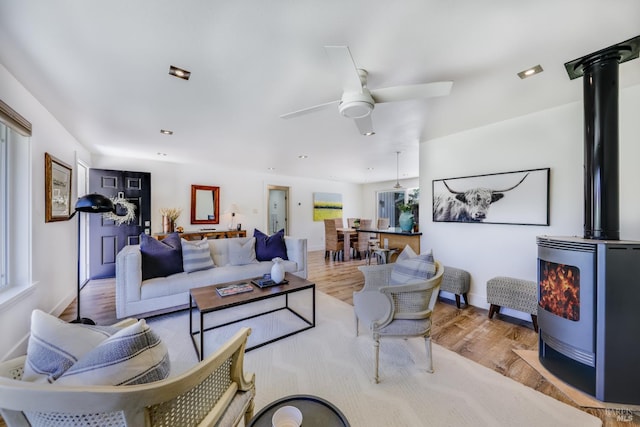 1067 Darms Ln, Napa, CA 94558 - living room with a wood stove, ceiling fan, wood finished floors, and baseboards