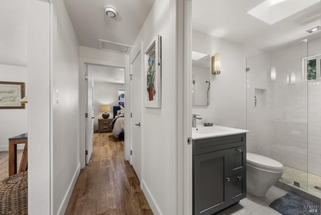 1067 Darms Ln, Napa, CA 94558 - ensuite bathroom featuring vanity, wood finished floors, a shower stall, toilet, and baseboards