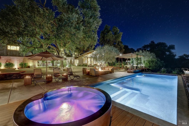 1067 Darms Ln, Napa, CA 94558 - pool at twilight with an outdoor hot tub, a deck, an outdoor pool, and a patio area