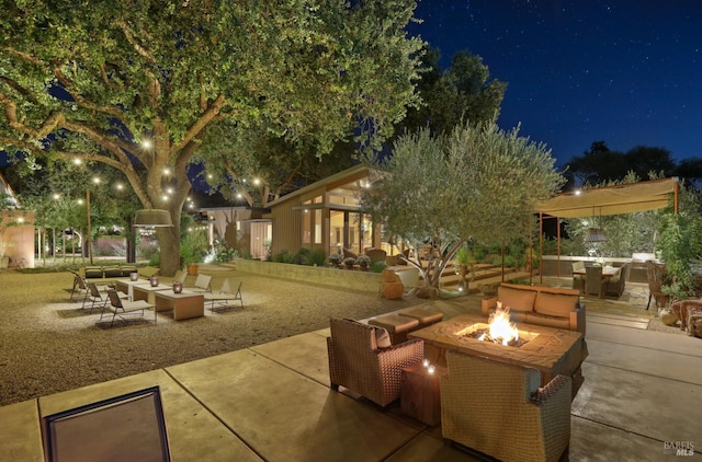 1067 Darms Ln, Napa, CA 94558 - patio at night with an outdoor living space with a fire pit and a patio area