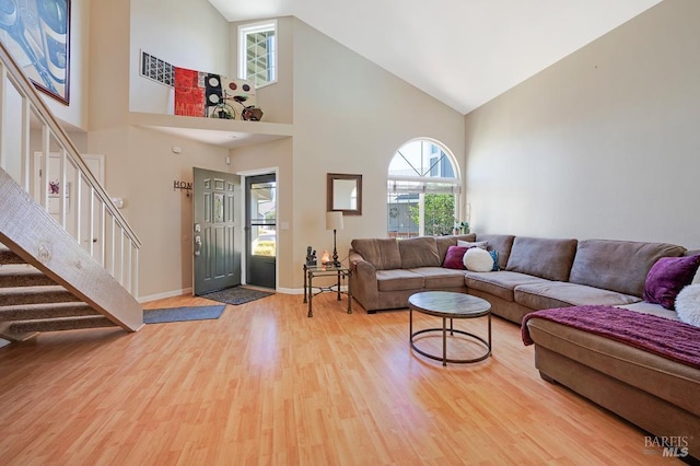 1405 Montana Pl, Rohnert Park, CA 94928 - living room with wood finished floors, high vaulted ceiling, healthy amount of natural light, stairs, and baseboards