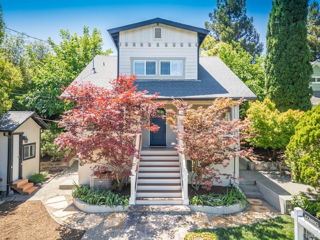 225 Berna Ave, Napa, CA 94559 - view of front facade featuring a shingled roof, entry steps, an outbuilding, and board and batten siding