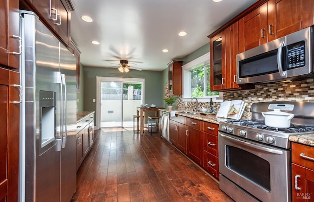 225 Berna Ave, Napa, CA 94559 - kitchen with appliances with stainless steel finishes, light stone countertops, backsplash, a ceiling fan, and dark wood finished floors