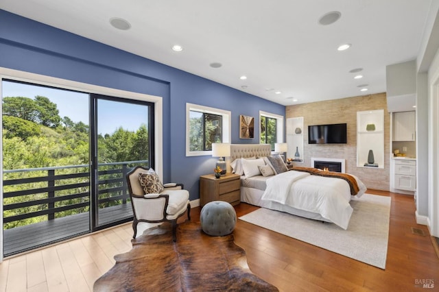 1131 W California Ave, Mill Valley, CA 94941 - bedroom with wood finished floors, a large fireplace, baseboards, and recessed lighting