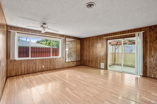 1205 Cambridge St, Novato, CA 94947 - unfurnished room featuring wood walls, light wood finished floors, ceiling fan, a textured ceiling, and baseboards