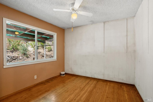 1205 Cambridge St, Novato, CA 94947 - unfurnished room featuring wood finished floors, a textured ceiling, and a ceiling fan