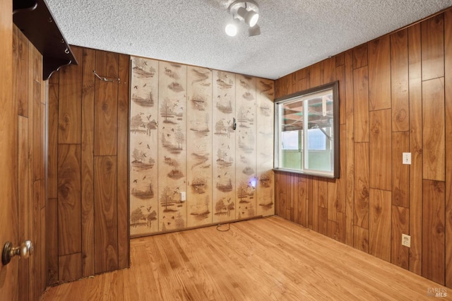1205 Cambridge St, Novato, CA 94947 - unfurnished room featuring a textured ceiling, wood finished floors, and wood walls