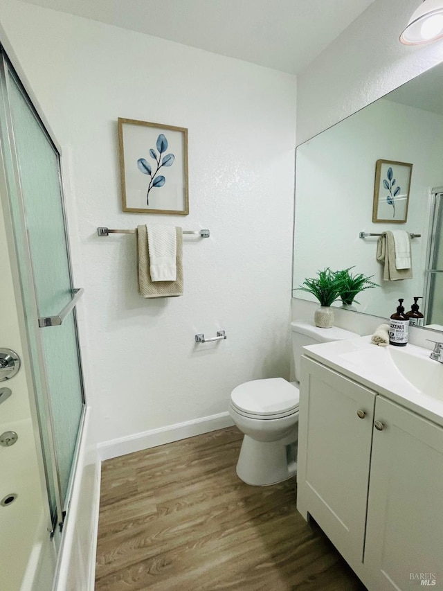 225 Pennsylvania Ave Unit B1, Fairfield, CA 94533 - bathroom with vanity, wood finished floors, toilet, and combined bath / shower with glass door