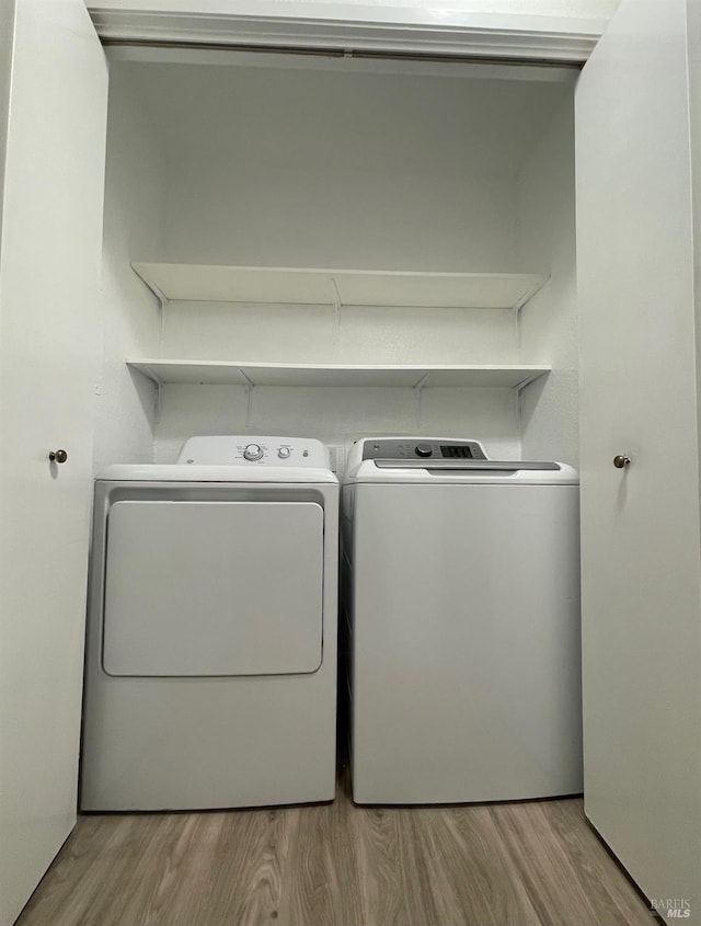225 Pennsylvania Ave Unit B1, Fairfield, CA 94533 - washroom featuring washing machine and clothes dryer and wood finished floors