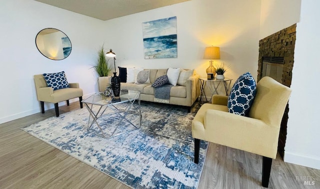 225 Pennsylvania Ave Unit B1, Fairfield, CA 94533 - living room with wood finished floors, baseboards, and a stone fireplace