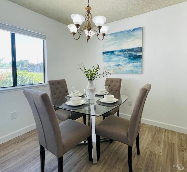 225 Pennsylvania Ave Unit B1, Fairfield, CA 94533 - dining area with a chandelier, baseboards, wood finished floors, and a textured ceiling