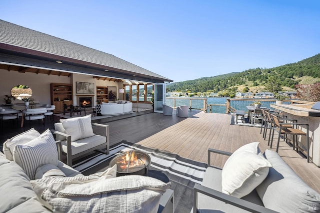 189 Seadrift Rd, Stinson Beach, CA 94970 - wooden deck featuring an outdoor living space with a fire pit and a forest view