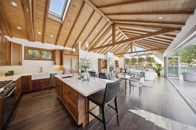 189 Seadrift Rd, Stinson Beach, CA 94970 - kitchen with a sink, stainless steel appliances, brown cabinets, wood ceiling, and a kitchen breakfast bar