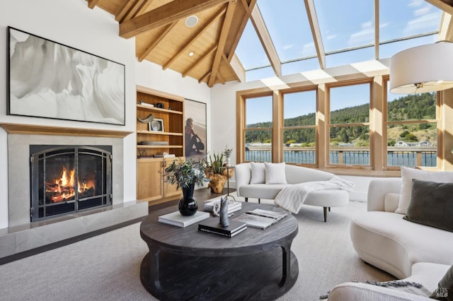 189 Seadrift Rd, Stinson Beach, CA 94970 - carpeted living area featuring beam ceiling, a glass covered fireplace, high vaulted ceiling, and built in shelves