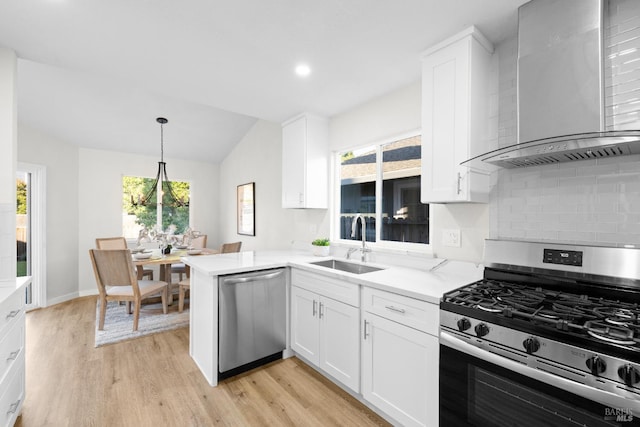 2410 Pinercrest Dr, Santa Rosa, CA 95403 - kitchen featuring appliances with stainless steel finishes, wall chimney range hood, a sink, vaulted ceiling, and light wood-style flooring