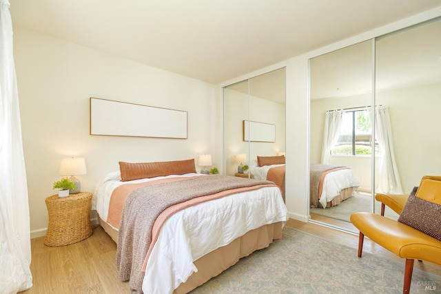 8201 Camino Colegio Unit 17, Rohnert Park, CA 94928 - bedroom featuring two closets, light wood-style floors, and baseboards