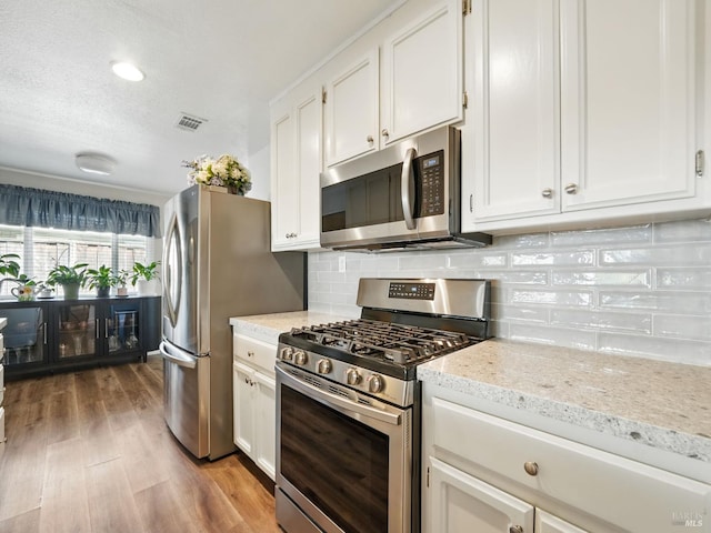 1233 Lincoln St, Fairfield, CA 94533 - kitchen with stainless steel appliances, white cabinets, wood finished floors, and recessed lighting