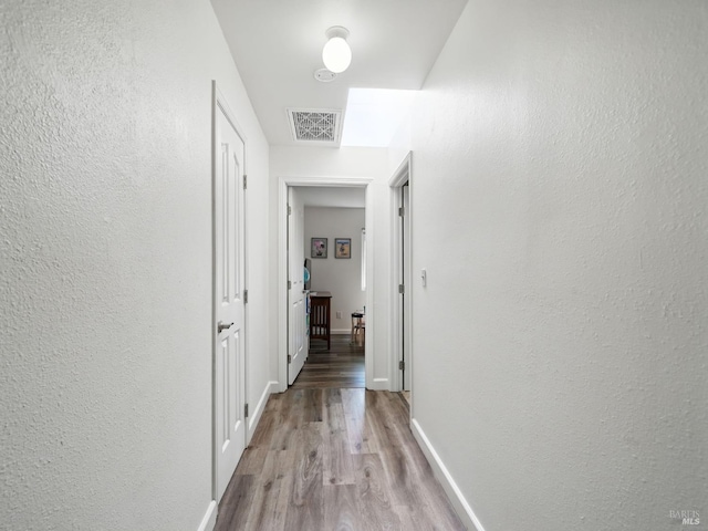 1233 Lincoln St, Fairfield, CA 94533 - hallway featuring wood finished floors, baseboards, and a textured wall