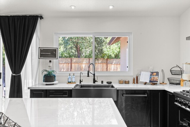 9508 Jessica Dr, Windsor, CA 95492 - kitchen with dark cabinets, a sink, light countertops, stainless steel gas range, and recessed lighting