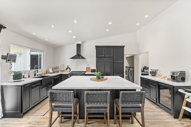 9508 Jessica Dr, Windsor, CA 95492 - kitchen featuring independent washer and dryer, wall chimney exhaust hood, beverage cooler, high end fridge, and light wood finished floors