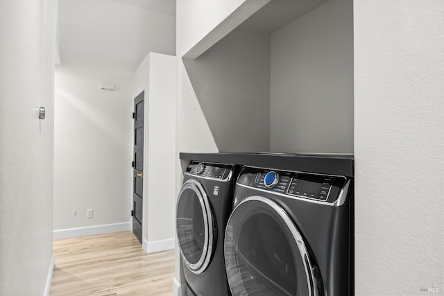 9508 Jessica Dr, Windsor, CA 95492 - laundry room featuring washing machine and dryer, light wood finished floors, and baseboards