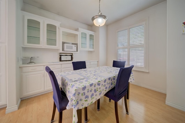 3543 Oak Shores Dr, Stockton, CA 95209 - dining area with light wood-style flooring and baseboards