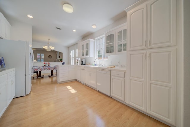 3543 Oak Shores Dr, Stockton, CA 95209 - kitchen with white appliances, a chandelier, glass insert cabinets, white cabinets, and light wood-style flooring