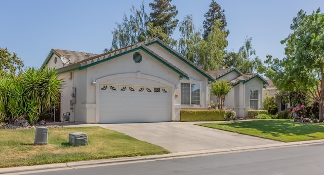 3543 Oak Shores Dr, Stockton, CA 95209 - ranch-style home with a garage, a tiled roof, driveway, and stucco siding