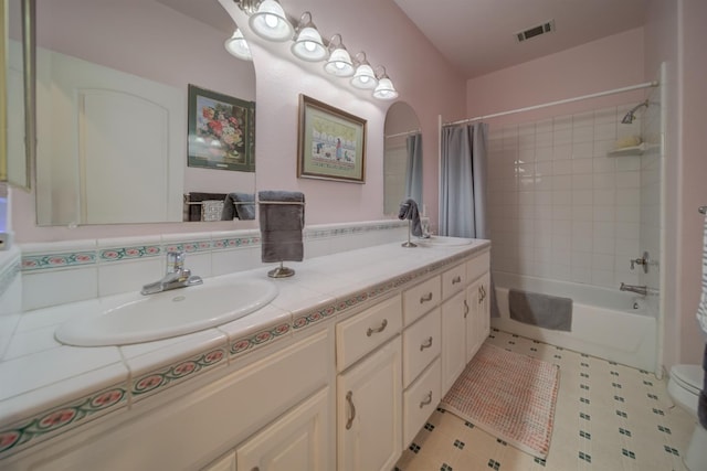 3543 Oak Shores Dr, Stockton, CA 95209 - bathroom featuring double vanity, shower / bath combo with shower curtain, and toilet