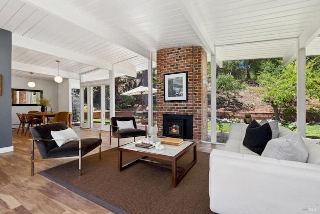 100 De La Guerra Rd, San Rafael, CA 94903 - living room with expansive windows, beam ceiling, wood finished floors, and a brick fireplace