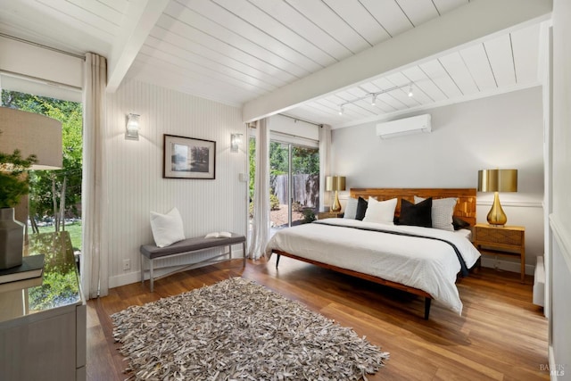 100 De La Guerra Rd, San Rafael, CA 94903 - bedroom with a wall unit AC, access to outside, beam ceiling, and wood finished floors